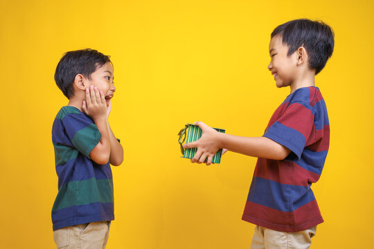 Two Boys Sharing Joyful Surprise Gift Moment Together