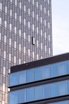 Abstract urban facade pattern with modern glass windows and grid architecture on contemporary building exterior