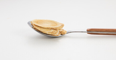 Astragalus Slices in Wooden-Handled Spoon