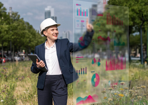 Engineer using augmented reality data analysis outdoors in city