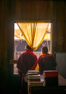 Novices monks looking thru a window, Inle lake, Myanmar