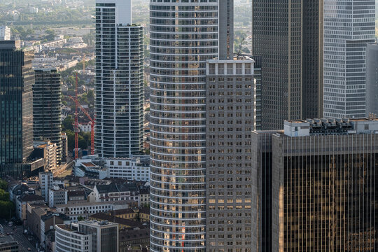 Glass towers of a Frankfurt Germany skyscraper cluster rise over the downtown offices and business core with striking architecture in daylight