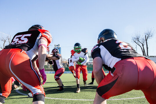 American football player running with the ball during a match