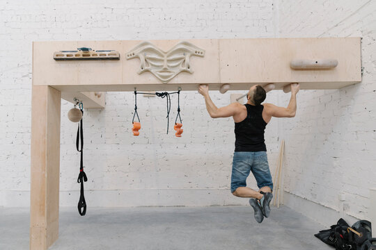 Man doing pull-ups before climbing