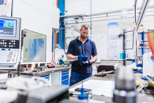 Man holding tool in industrial factory
