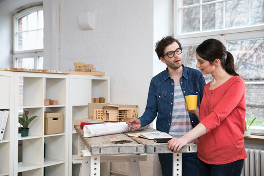 Man and woman discussing draft in office