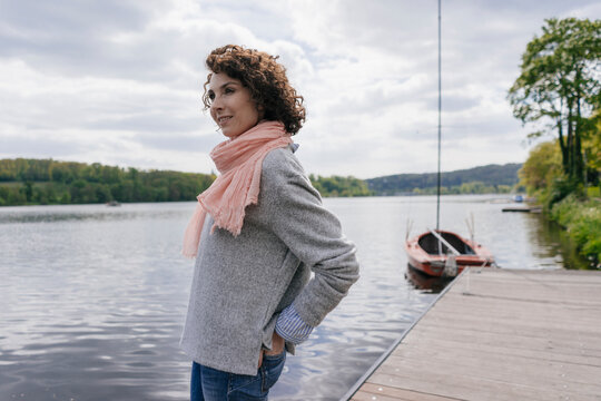 Woman standing at lake looking at view