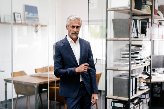 Portrait of serious mature businessman in office