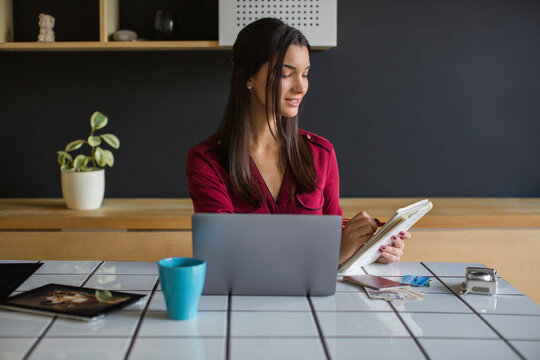 Young woman using laptop, travel booking