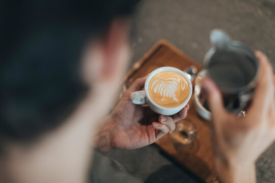 Man preparing milk coffee