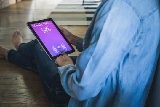 Young woman with tablet with smart home control functions