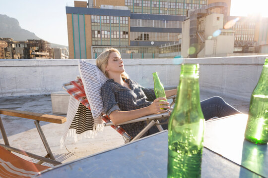 Young woman relaxing on her terrace