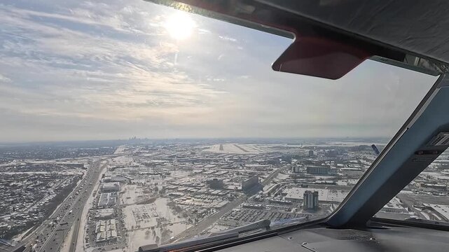 Approach and landing from Pilots point of view (POV) at Toronto Pearson International Airport in Canada - Cockpit View with scenic winter landscape before landing - 4k aerial video footage