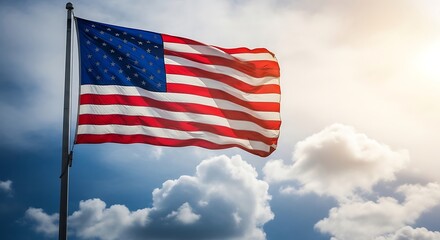 Obraz premium A US flag waving proudly in the wind against a dramatic sky with sun shining through clouds