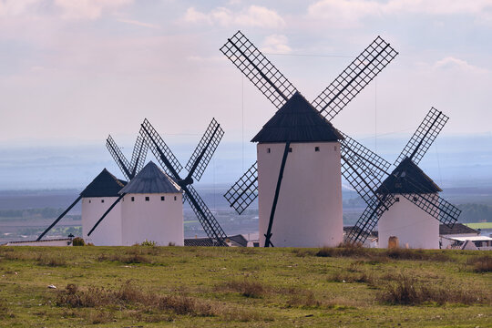 View of the iconic windmills standing proudly against the vast landscape, painting a picturesque scene of rural charm, Campo de Criptana, Castile-La Mancha, Spain.