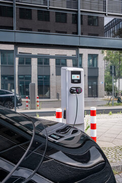 Sustainable urban street technology for electric vehicle charging station with plug connection improving clean transport and modern mobility