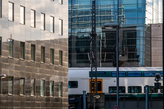 Modern architecture corridor with city tram on rail street showing public transport commuting and urban mobility in a contemporary setting