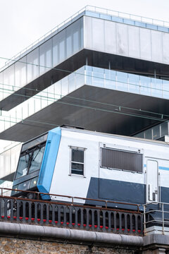 Modern Paris station scene with train on railway transport lines as contemporary architecture frames urban commuting infrastructure