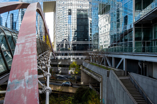 Glass urban landmark near Paris Defense business zone with modern office architecture shaping the city transport scene in daylight