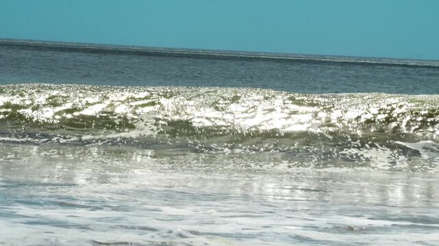 small wave crashing in slow motion