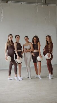 Portrait Multicultural Pregnant women and trainer exercising together, group fitness for expecting mothers.