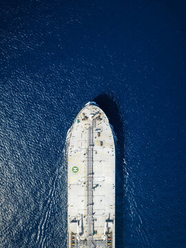 High aerial overhead view of a crude oil tanker traveling over the ocean with copy space