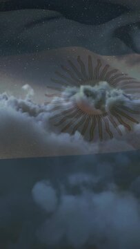 Vertical video: Waving flag with sun emblem drifting in stars, clouds revealing emblem for branding