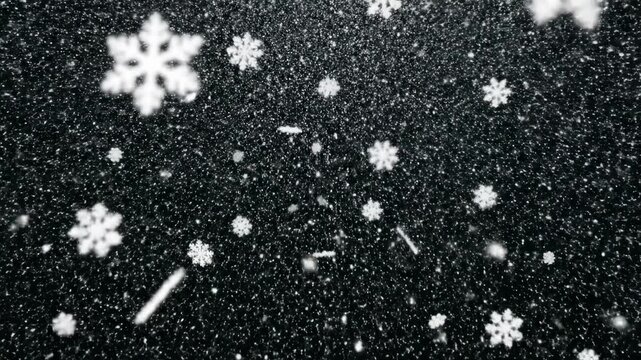 Snowflakes gently falling through the air against a dark background, creating a serene winter atmosphere with a gradual increase in snowfall density and visibility