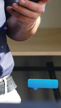 Vertical video: Man lifting phone and tapping screen checking social stats as blue bubbles updating