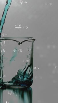 Vertical video: Turquoise stream entering upper left, pouring into clear beaker, showing turbulence