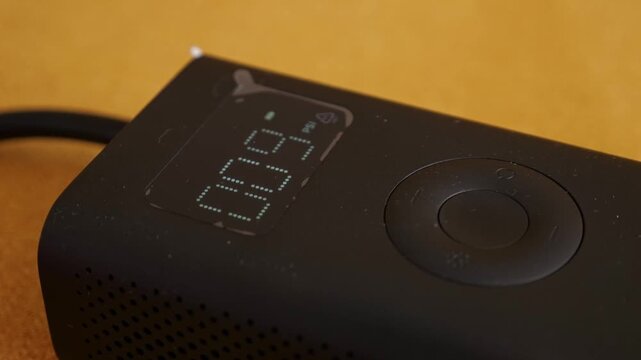 Digital Pressure Gauge On Device. Compact Portable Inflator With Digital Readout And Control Dial. Small Portable Air Compressor Showing Precise Pressure Measurement And Flexible Rubber Hose