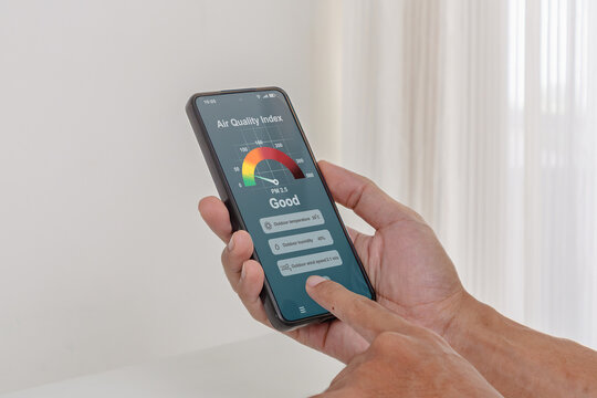 A man checking the outdoor air quality index using an app on his smartphone