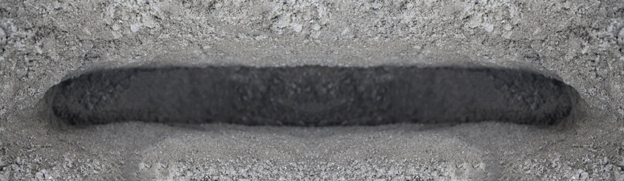 Sand pit trap pile of dark soil with a hole in the middle, as background top aerial view