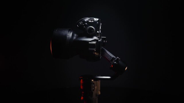 new electronic gyroscopic stabilizer for small SLR and mirrorless cameras and still cameras controlled via smartphone or joystick