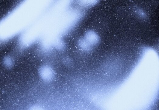 Blue vintage film grain texture with light bokeh and dust scratches