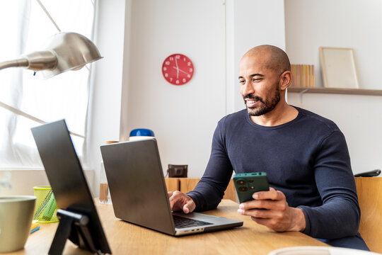 Mid man working at home office celebrating course completion