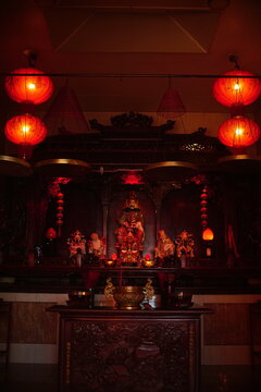 Shrine altar illuminated by red lanterns inside Kelenteng Eng An Kiong temple, Malang, East Java.