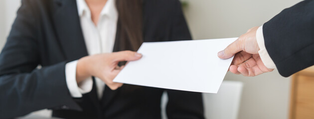 Fototapeta premium Good job, asian manager business giving financial reward in an envelope, business letter extra salary to company employee, woman worker office hand received premium bonus, getting cheque from her boss