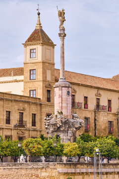 View of the Triumph of Saint Raphael stands tall against the backdrop of aged stone buildings, creating a timeless scene, Cordoba, Andalusia, Spain.