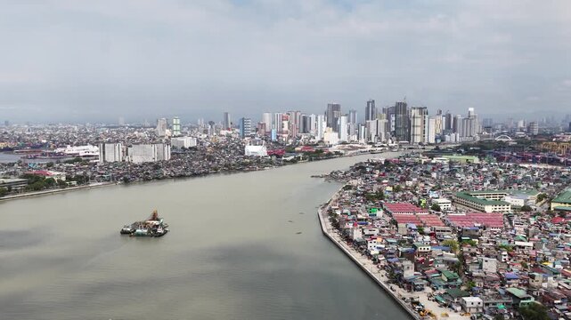 High altitude drone footage capturing the stark contrast between the dense tondo district slums and the modern skyline of manila, with a dredger boat navigating the polluted pasig river