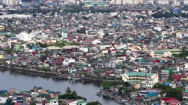Aerial view of a densely populated urban residential area with impoverished housing, showing the stark contrast of poverty and overpopulation in a developing country's metropolitan city