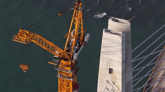Aerial view of a tower crane building a concrete bridge pylon