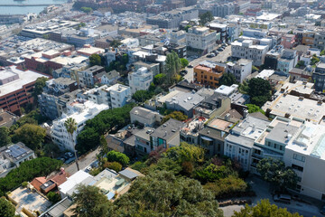 View of San Francisco buildings with greenery and urban areas in the background near the bay