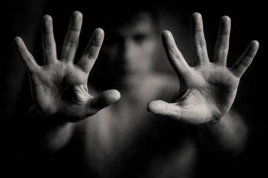 The Hands Reaching Forward in Dramatic Black and White Portrait with Blurred Face