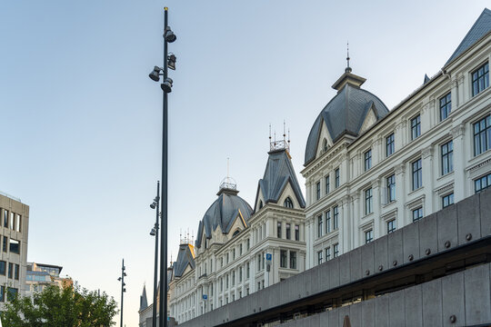 View of the Grand Hotel's ornate facade rises majestically against the clear sky, its intricate details catching the sunlight, Oslo, Oslo, Norway.