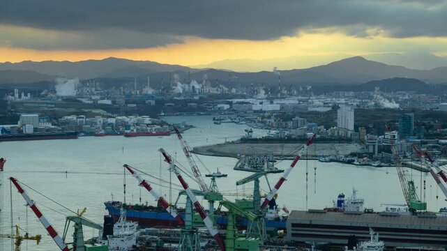Ulsan Industrial Skyline Day to Night Timelapse. Oil Refineries, Petrochemical Plants, Shipyard Cranes and Taehwa River at Sunset with Dramatic Clouds