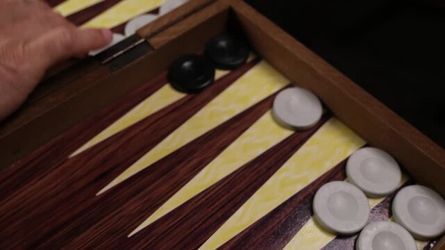 Backgammon player hitting an opponent's blot on the board