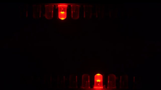 Chasing running light on red LED line in dark environment.