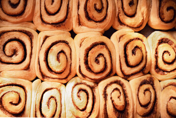 Traditional recipe cinnamon rolls. Process of making sweet pastry in home kitchen. Delicious dessert idea for Easter or weekend breakfast. Top view.