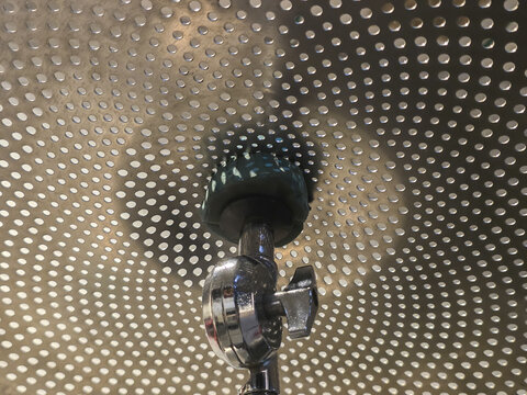 Powerful spinning machine with rotating beater creates dynamic motion blur. industrial metal equipment inside perforated steel drum represents technology and force